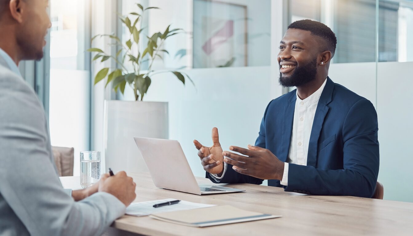 African American young male sitting across a table in an interview